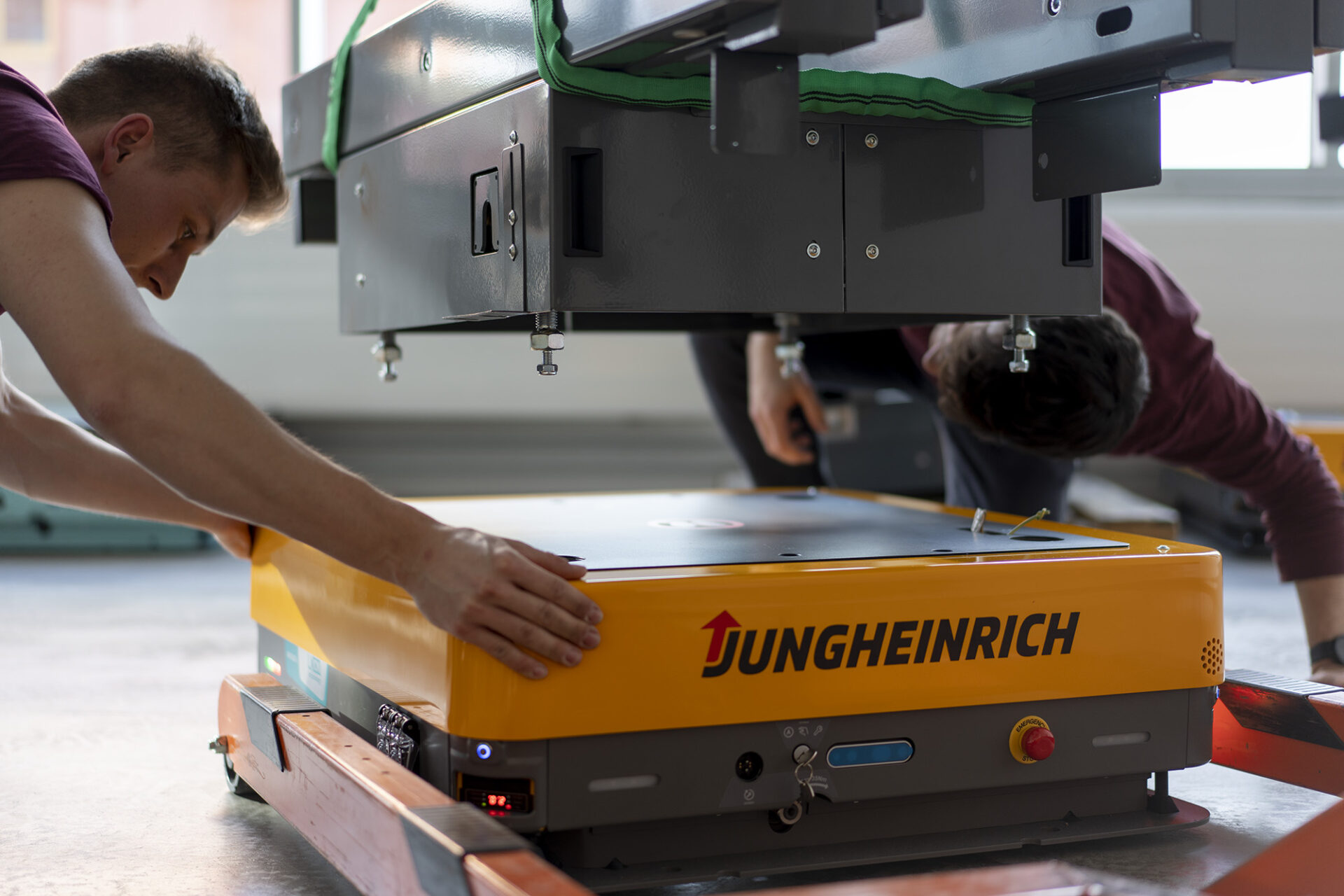 Two engineers working on installing a conveyor backpack on the arculee